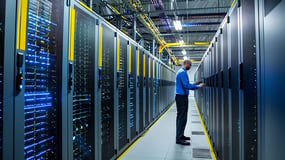 male-technician-blue-shirt-glasses-works-server-large-data-center