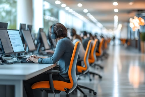 modern-call-center-with-ergonomic-workstations-blurred-employees-background